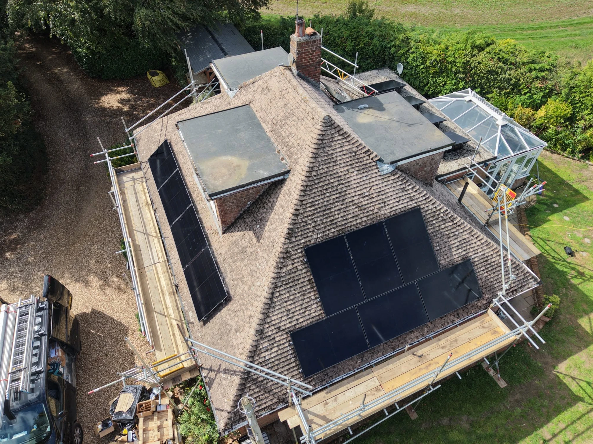 Drone view of roof repairs in progress with scaffolding